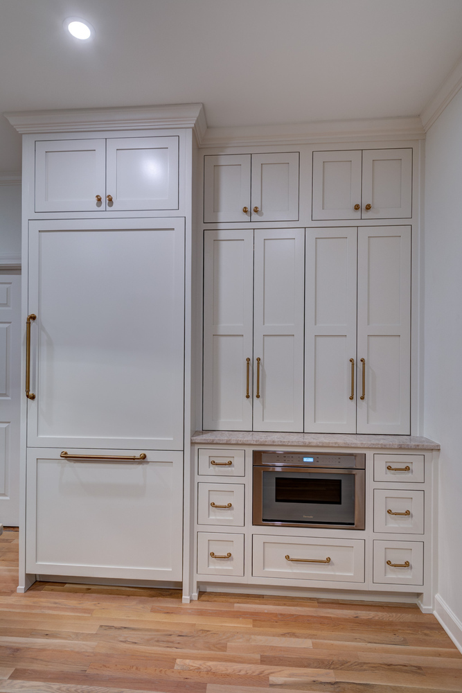 Closed cabinet storage for appliances and built-in microwave in remodeled Atlanta kitchen by Silver Oak Remodel