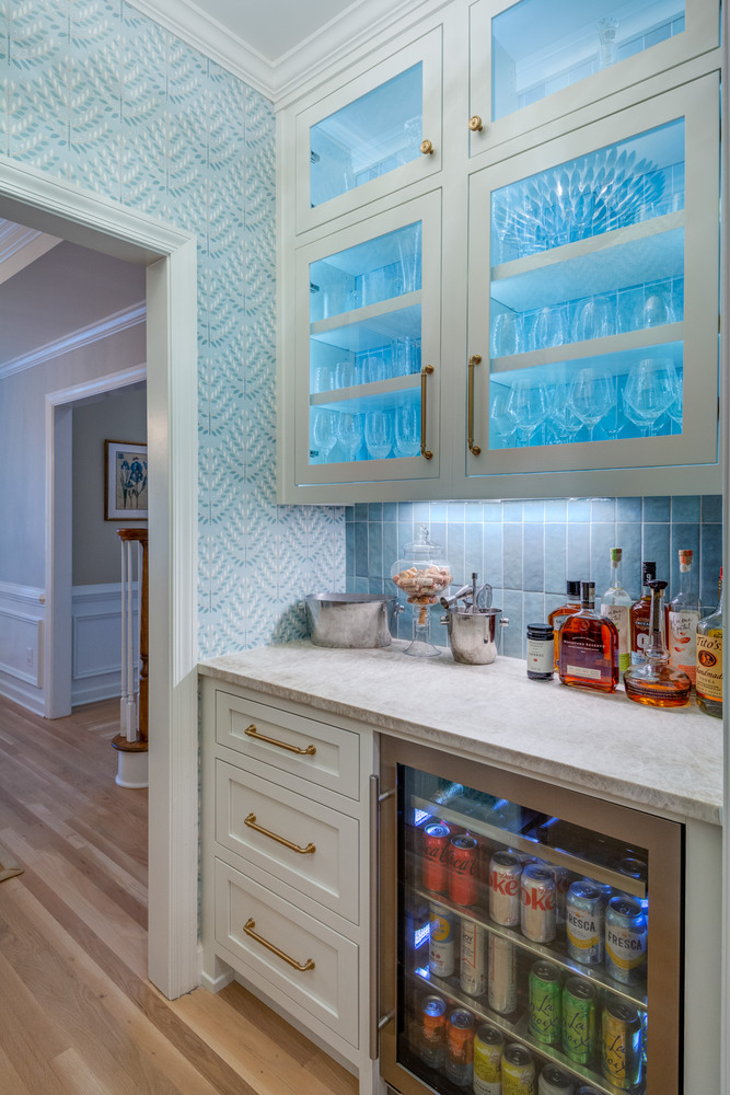 Custom wet bar with glass cabinetry and beverage cooler by Silver Oak Remodel in Atlanta, Georgia