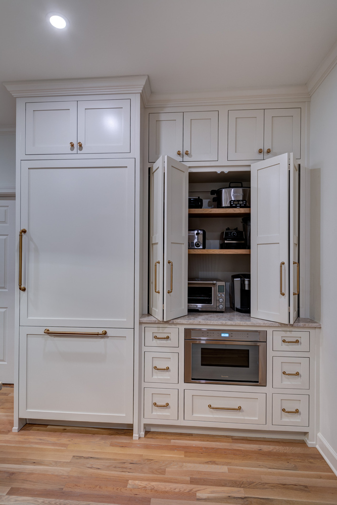 Hidden appliance storage with cabinet doors open in custom kitchen remodel by Silver Oak Remodel in Atlanta, GA