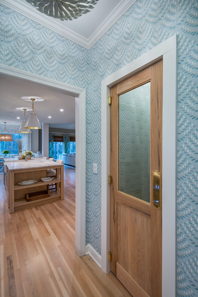 Kitchen entryway with custom door and view into remodeled open-concept space by Silver Oak Remodel in Atlanta, GA