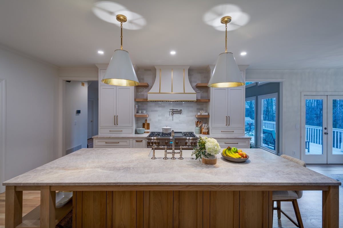 Large kitchen island with seating and overhead pendant lights by Silver Oak Remodel in Atlanta, GA