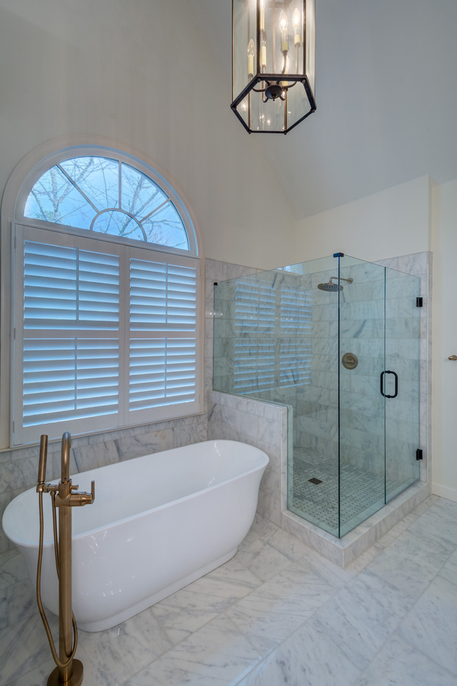 Modern freestanding bathtub and glass shower in luxury bathroom remodel by Silver Oak Remodel in Atlanta, GA