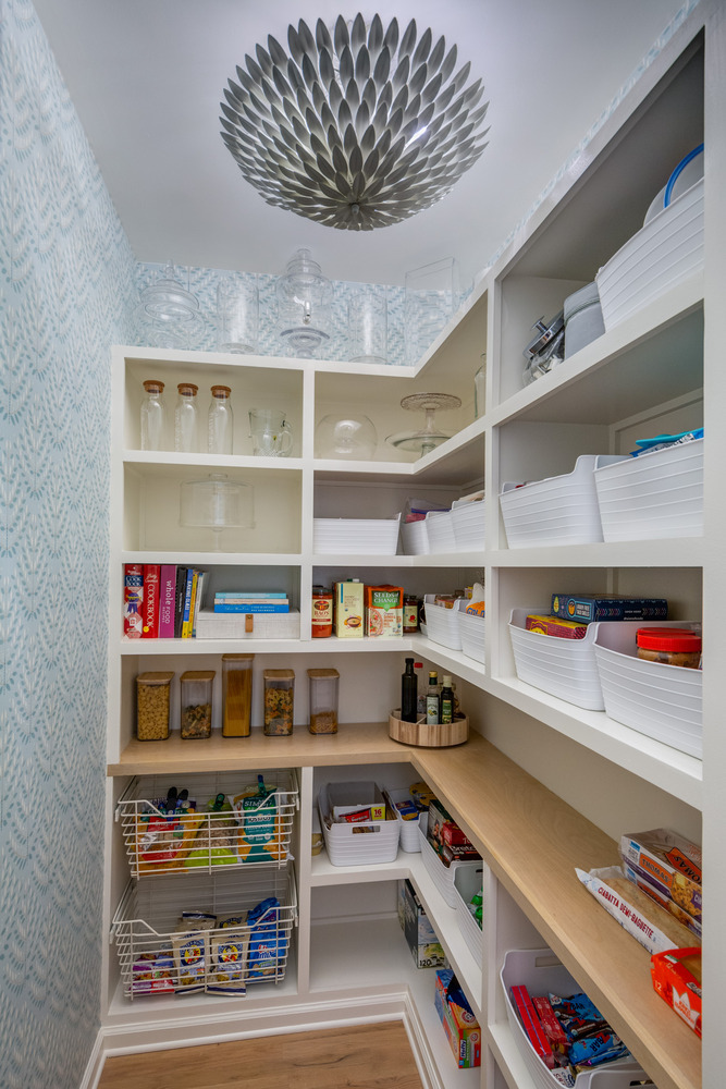 Organized walk-in pantry with custom shelving and patterned wallpaper by Silver Oak Remodel in Atlanta, GA
