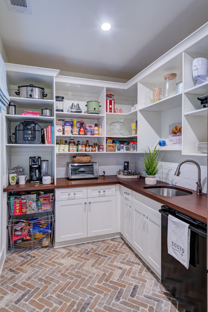 Walk-in pantry with open shelving and wood counters completed by Silver Oak in Roswell, GA