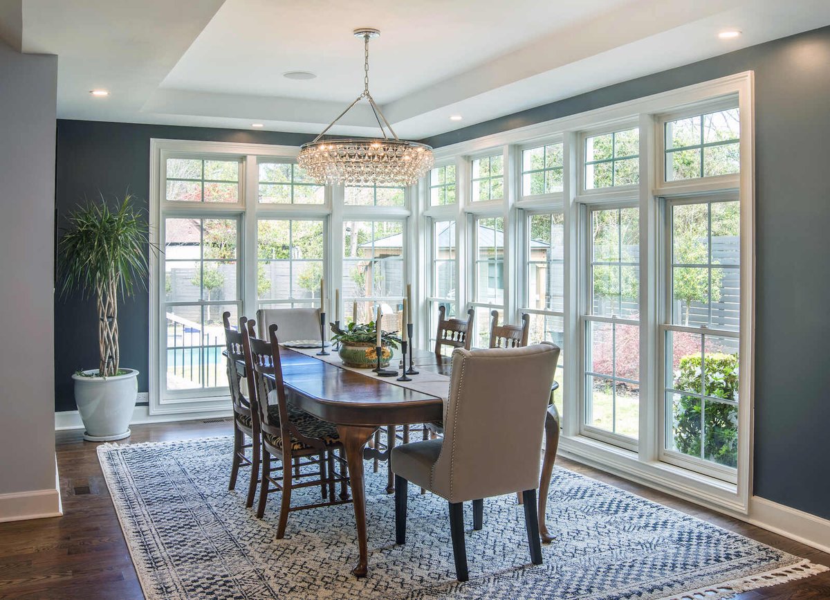 Dining area remodel by Silver Oak Remodel in East Cobb, GA with wall of windows and crystal chandelier