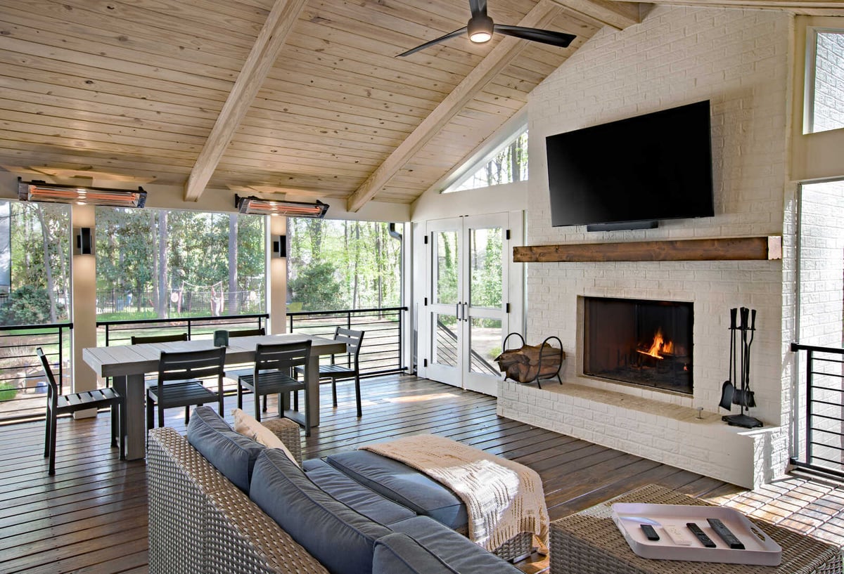 Elegant sunroom fireplace wall with vaulted ceiling by Silver Oak Remodel in Greater Atlanta