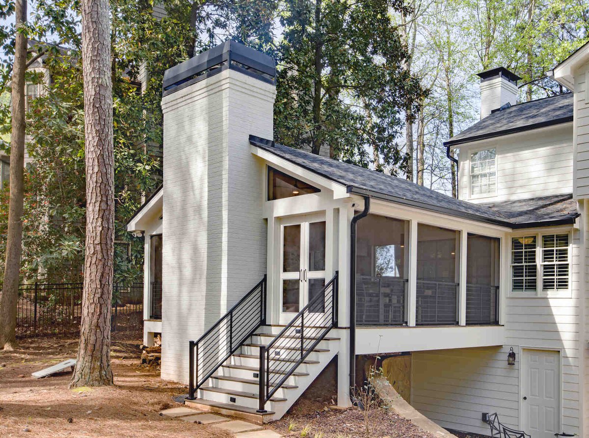Exterior view of sunroom addition with brick chimney by Silver Oak Remodel in Greater Atlanta