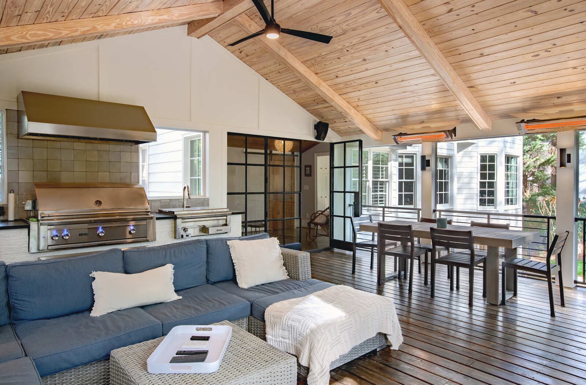 Outdoor kitchen and lounge area in sunroom addition by Silver Oak Remodel in Greater Atlanta