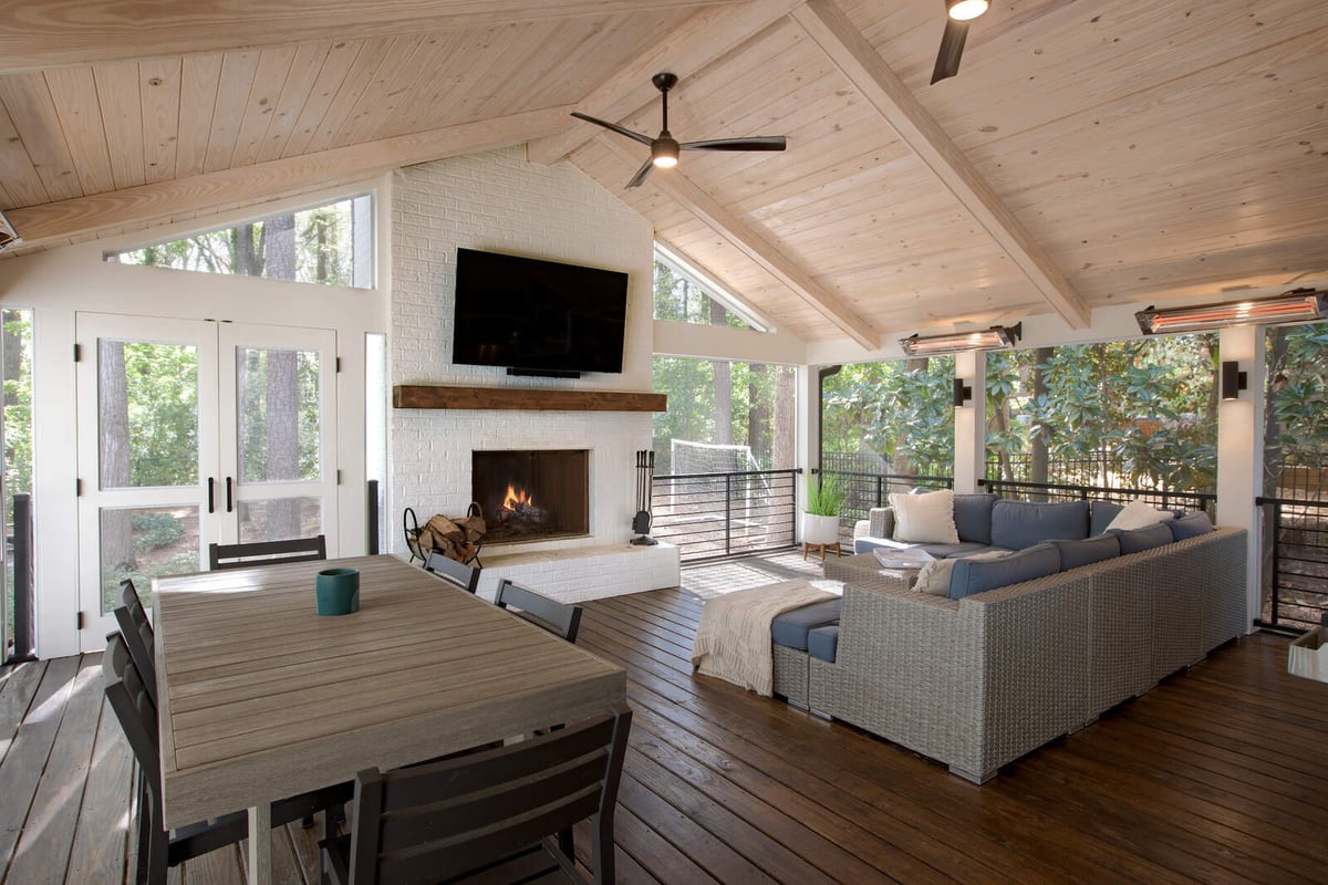 Sunroom addition with vaulted ceiling and brick fireplace by Silver Oak Remodel in Greater Atlanta
