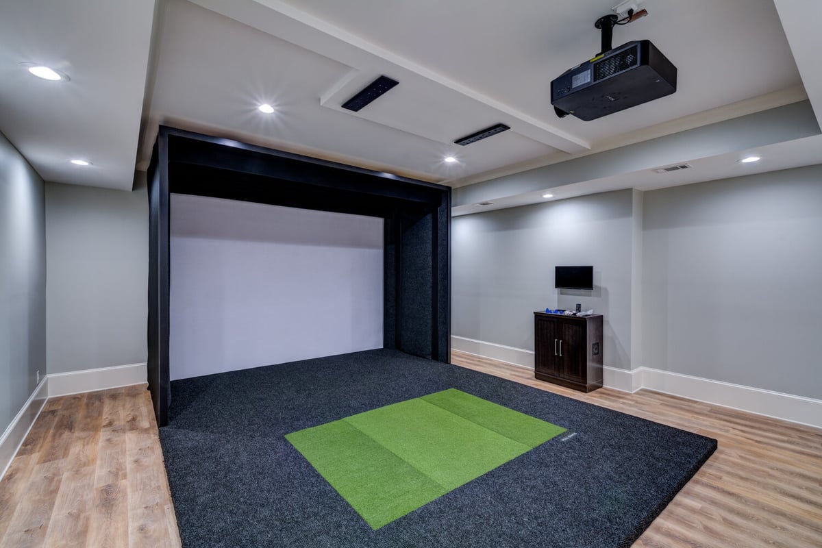 Basement golf simulator room with projector setup by Silver Oak Remodel in Greater Atlanta
