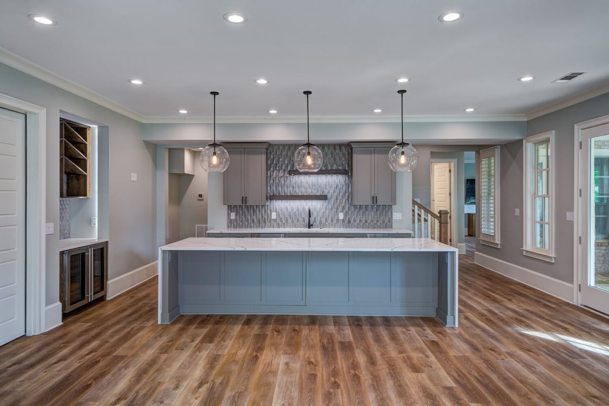 Basement kitchen remodel with modern lighting and grey cabinetry by Silver Oak Remodel in Greater Atlanta