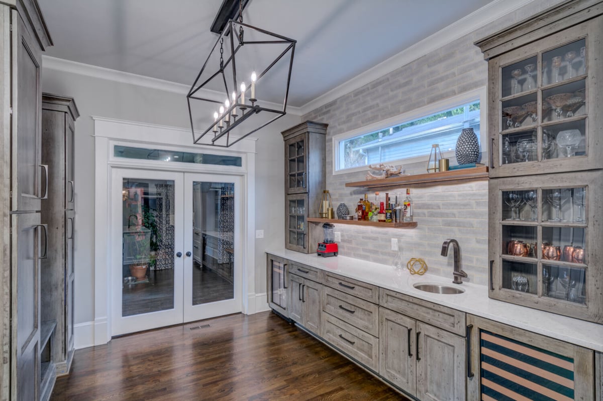 Custom gas cooktop with white cabinets and chevron backsplash by Silver Oak Remodel in Atlanta, GA
