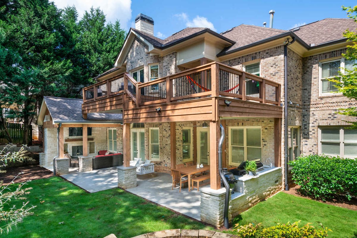 Spacious outdoor living space with two-story deck and covered patio by Silver Oak Remodel in Atlanta, GA