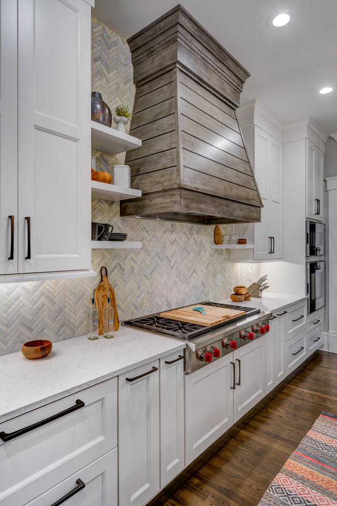 White kitchen island with farmhouse sink and pendant lights by Silver Oak Remodel in Atlanta, GA