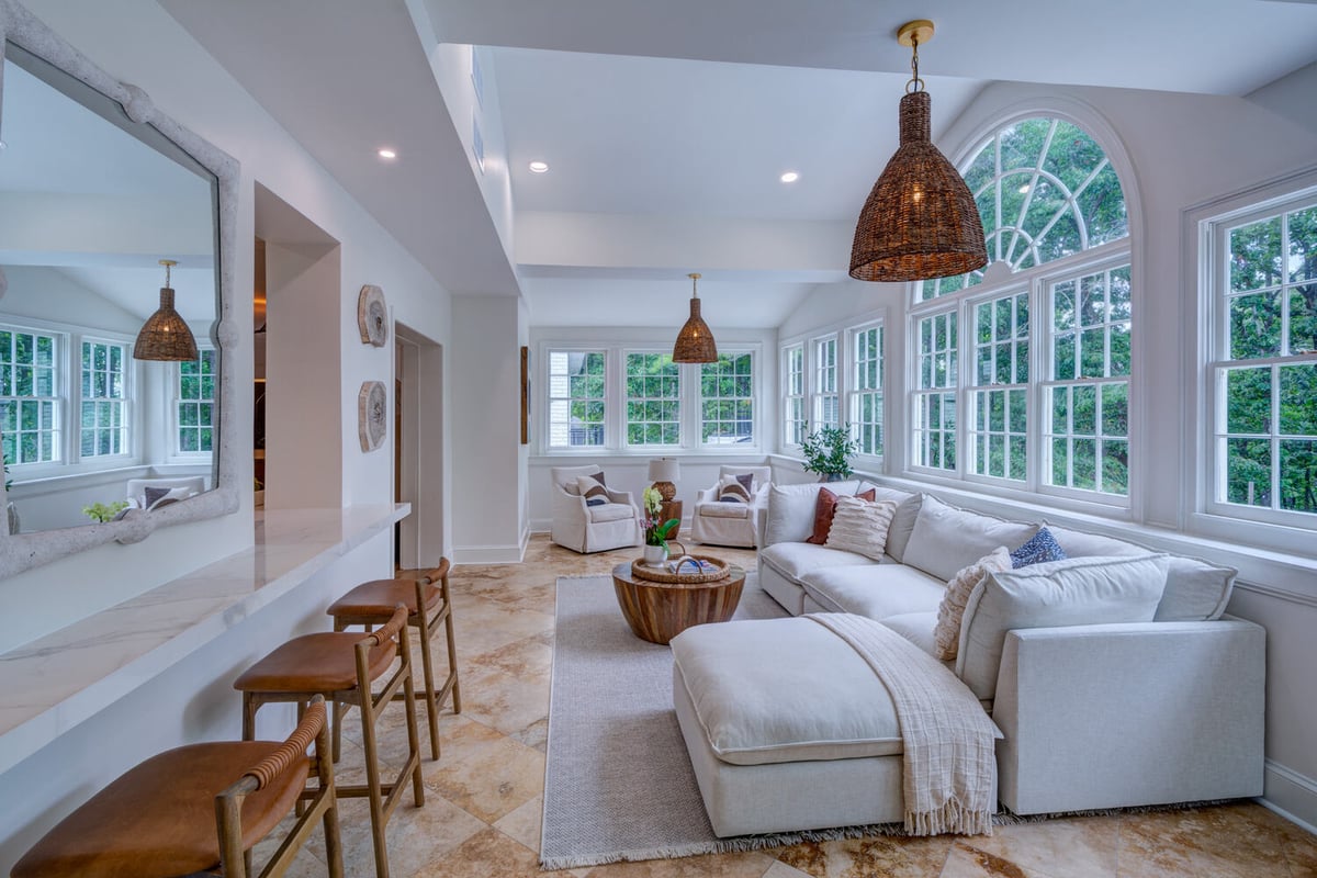 Elegant sunroom with ample seating and wood coffee table by Silver Oak Remodel in Greater Atlanta remodel
