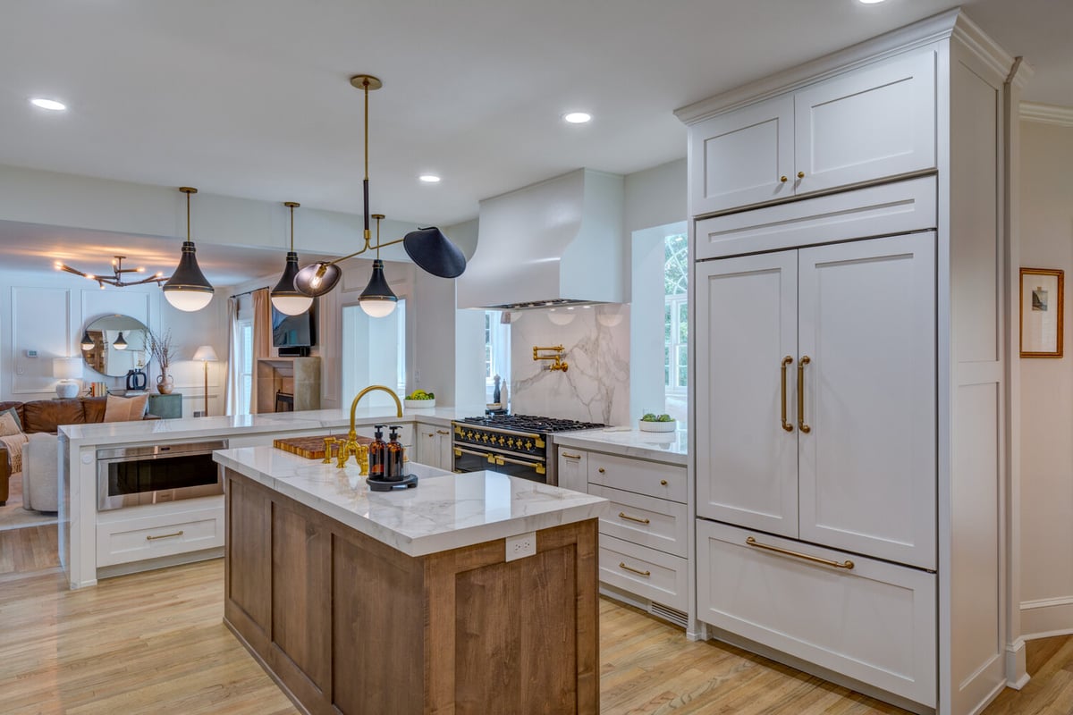 Luxury kitchen island with brass fixtures and marble countertops by Silver Oak Remodel in Greater Atlanta