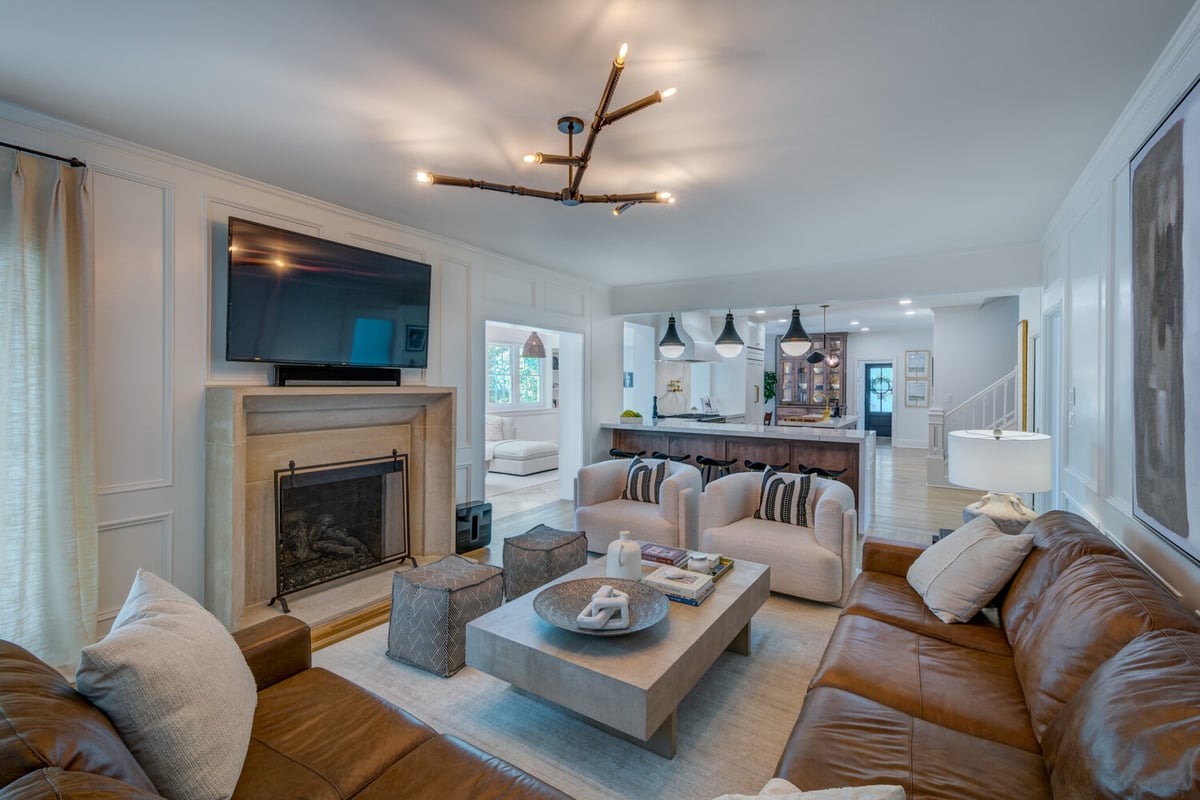 Stylish open-concept living room remodel by Silver Oak Remodel in Greater Atlanta with modern furnishings and fireplace