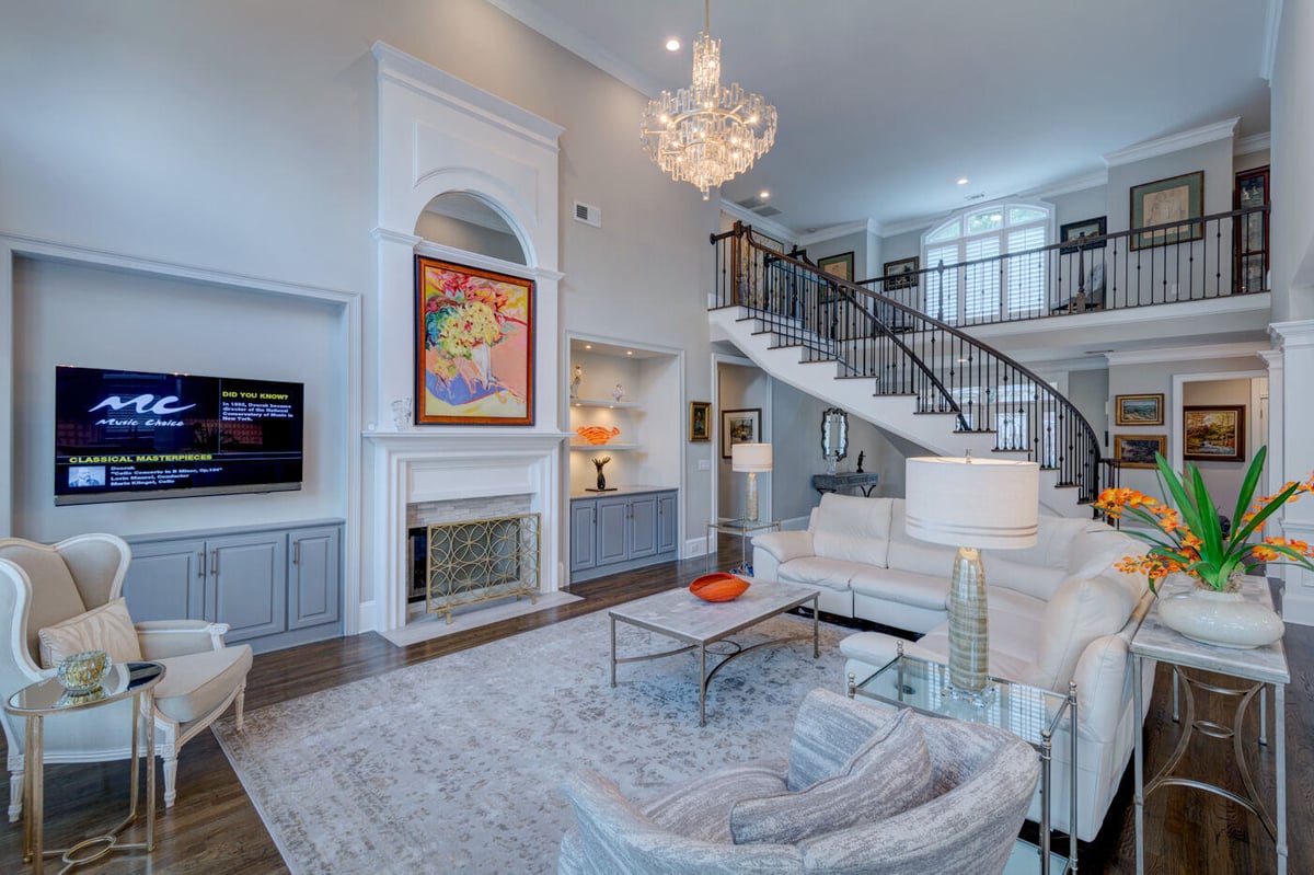Sophisticated living room remodel in Sandy Springs, GA with fireplace and custom trim by Silver Oak Remodel