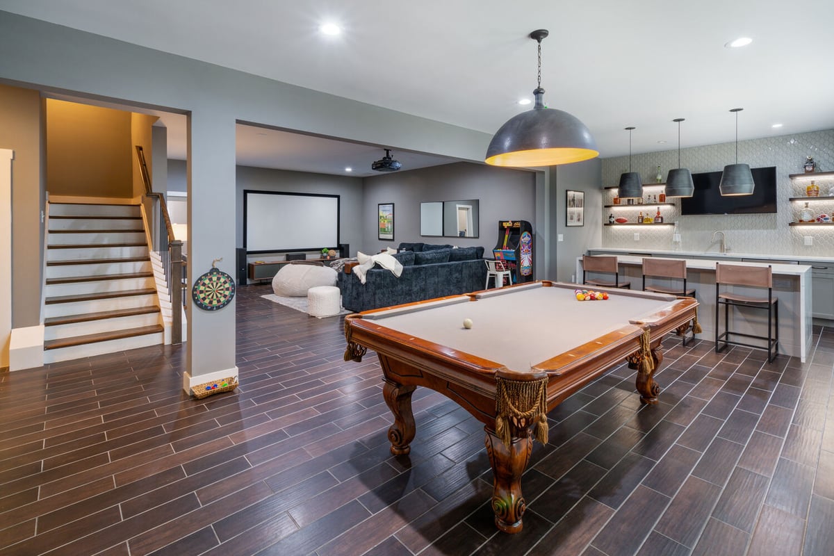 Basement renovation with open concept layout, bar, and theater seating by Silver Oak Remodel in Greater Atlanta