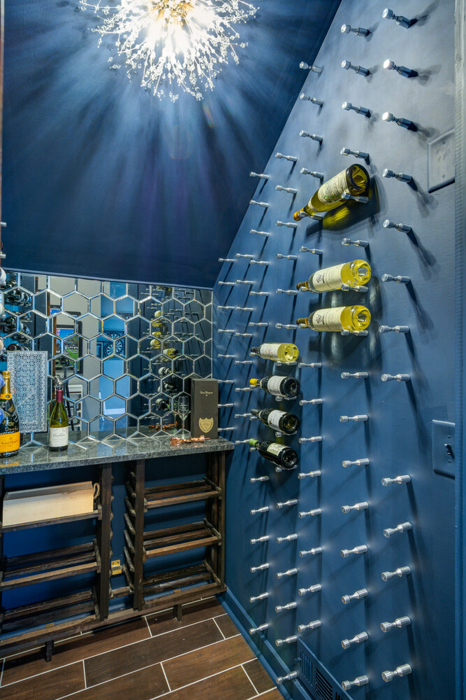 Custom wine room with bottle peg wall and mirrored tile backsplash by Silver Oak Remodel in Greater Atlanta