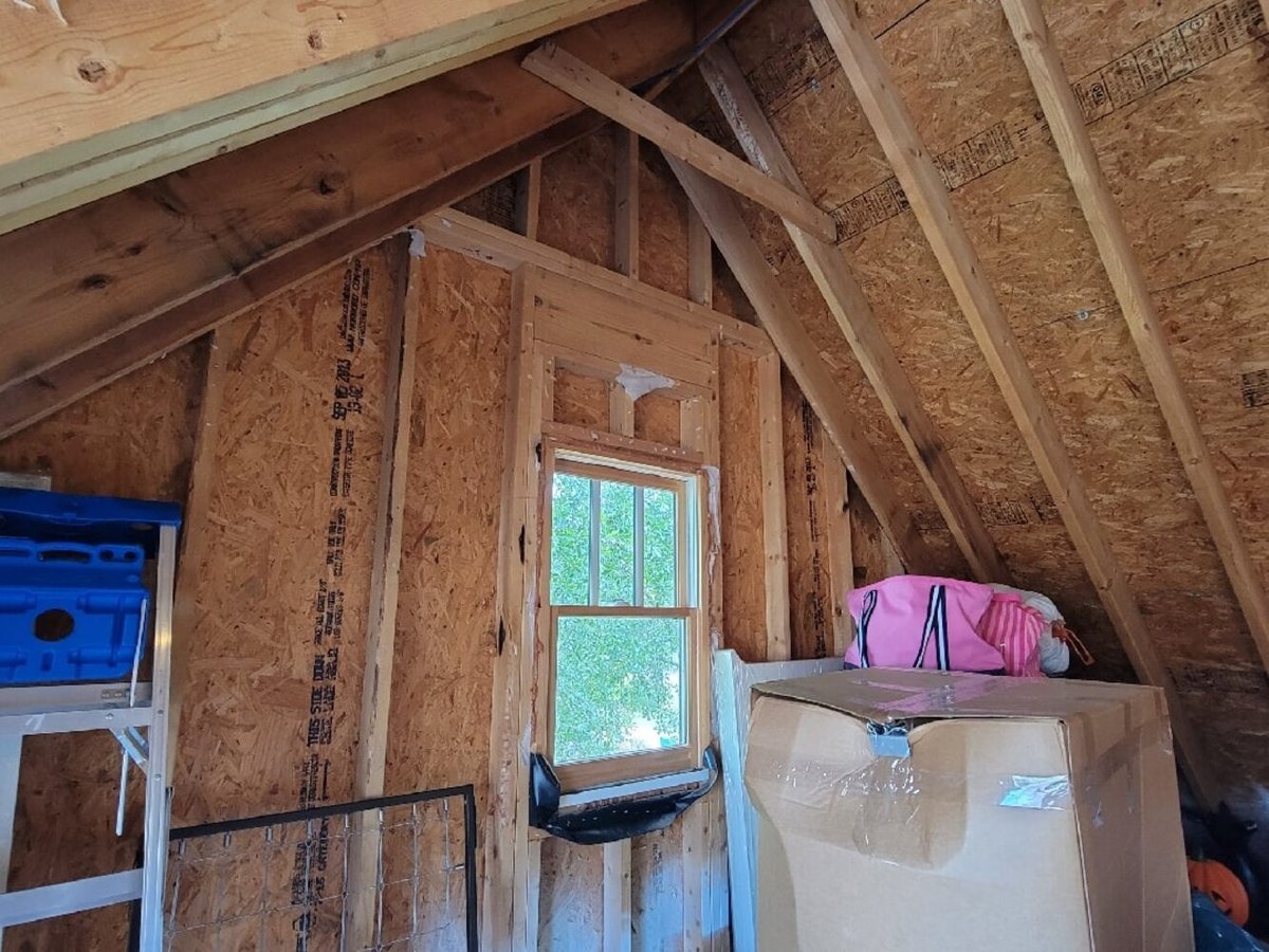 Unfinished attic space with visible OSB walls and exposed rafters before renovation by Silver Oak Remodel in Greater Atlanta
